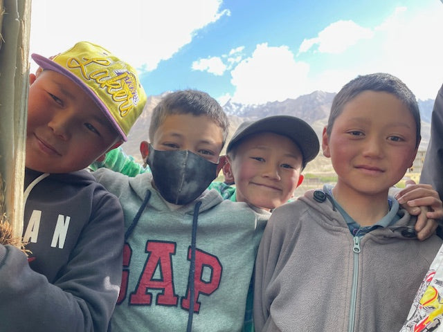 Children smiling together at a Skinjuvea community care visit